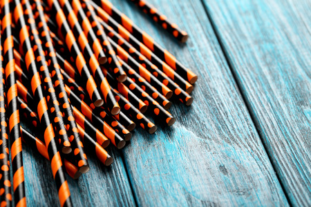 Striped drink straws on a blue wooden backgroundの写真素材