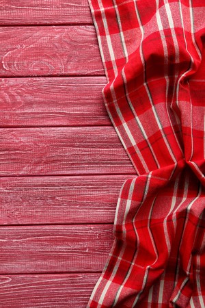 Napkin on red wooden table, close up