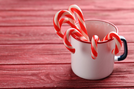 Christmas candy can on a red wooden tableの写真素材