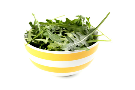 Fresh arugula leafs isolated on a whiteの写真素材