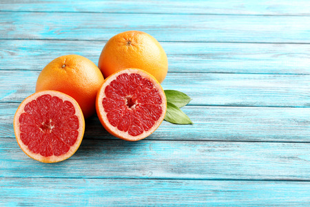 Grapefruit fruits on a blue wooden tableの写真素材