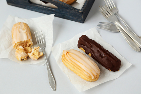 Sweet and tasty eclairs on a white background