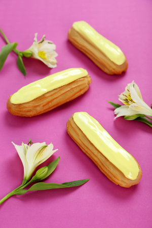Eclairs with glaze on a paper backgroundの写真素材