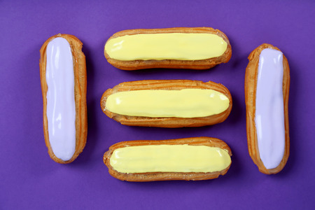Eclairs with glaze on a paper backgroundの写真素材