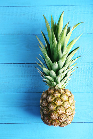 Ripe pineapple on a blue wooden tableの写真素材