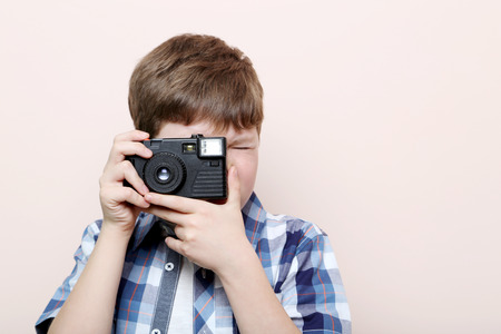 Portrait of young boy on pink backgroundの写真素材