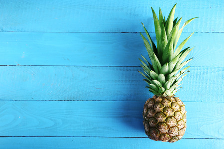 Ripe pineapple on a blue wooden tableの写真素材