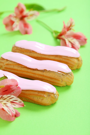 Eclairs with glaze on a paper backgroundの写真素材