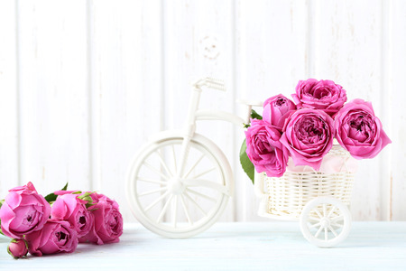 Beautiful pink roses on a white wooden tableの写真素材