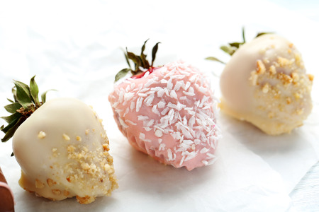 Strawberries covered in chocolate on a white pergamentの写真素材