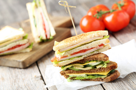 Tasty and fresh sandwiches on a grey wooden tableの写真素材