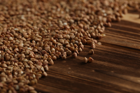 Buckwheat seeds on a brown wooden tableの写真素材