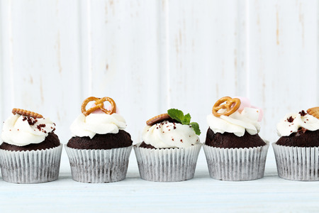 Chocolate cupcakes on a blue wooden tableの写真素材