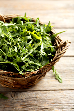 Fresh arugula leafs on a grey wooden tableの写真素材