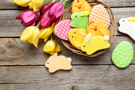 Colorful easter cookies on grey wooden background