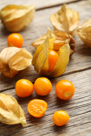 Ripe physalis on a grey wooden tableの写真素材