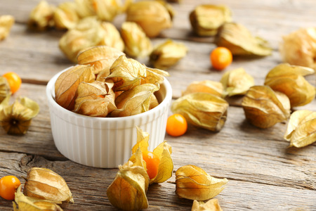 Ripe physalis on a grey wooden tableの写真素材