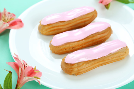 Eclairs with glaze on a paper backgroundの写真素材