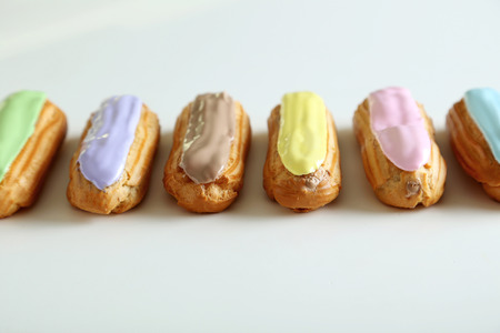 Eclairs with glaze isolated on a whiteの写真素材