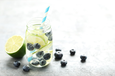 Detox water in bottle with berries on tableの写真素材