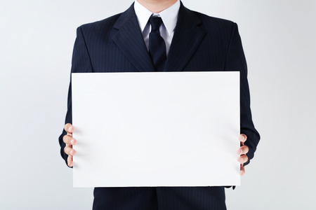 Businessman holding blank sheet of paper in his handsの写真素材