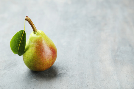 Ripe pear on grey wooden tableの写真素材