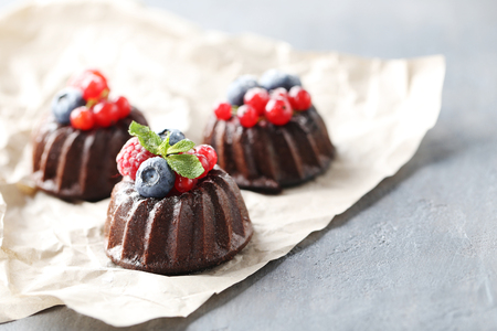 Sweet chocolate cakes with berries on grey tableの写真素材