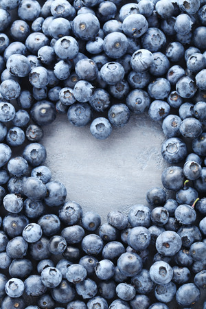 Ripe and tasty blueberries on grey wooden tableの写真素材