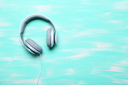 Headphones on a mint wooden table, close upの写真素材