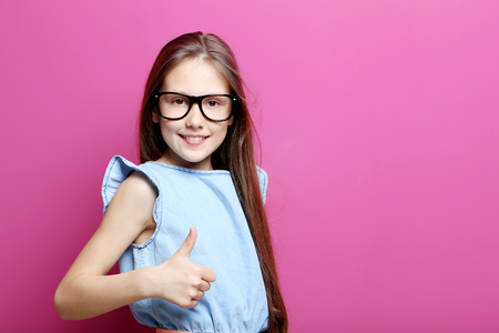Portrait of young girl on the pink background