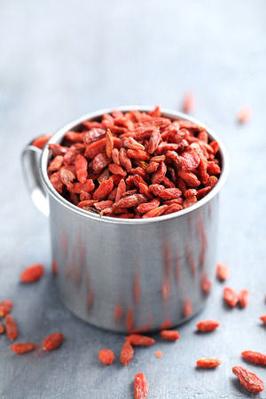 Dry goji berries on grey wooden tableの写真素材