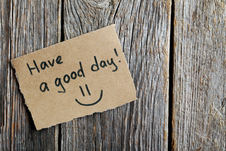 Piece of note paper on grey wooden backgroundの写真素材