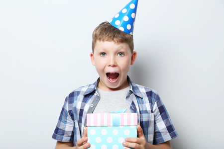 Portrait of  little boy in birthday cap on grey backgroundの写真素材