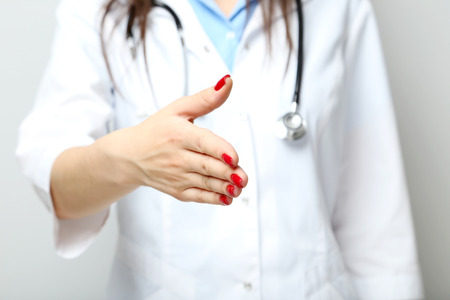 Medical doctor with a stethoscope reach out handの写真素材