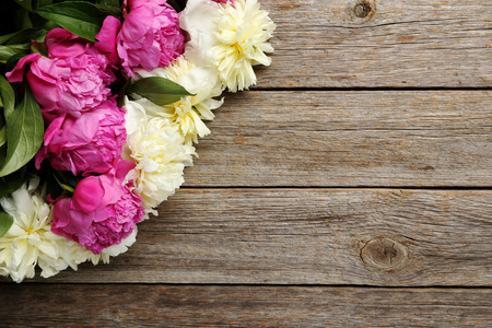 Bouquet of pink and white peony flowers on wooden tableの写真素材