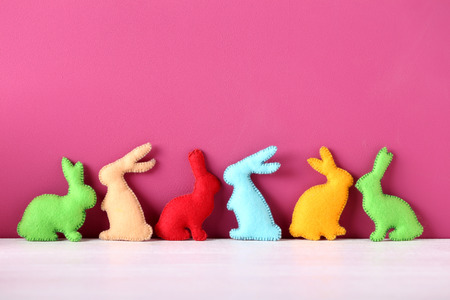 Handmade easter rabbits on pink backgroundの写真素材