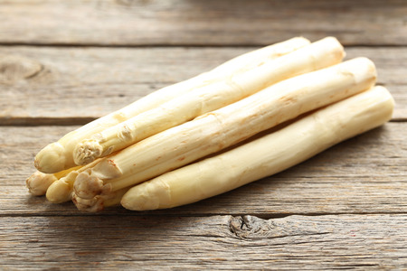 Fresh white asparagus on a grey wooden tableの写真素材