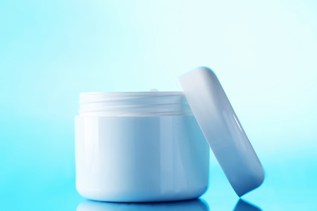 White cosmetic bottle on a blue backgroundの写真素材