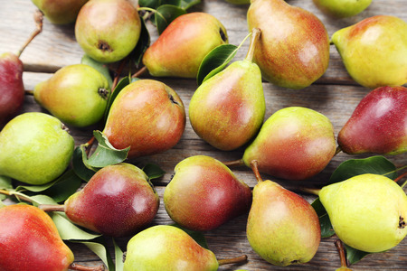 Ripe pears on grey wooden table