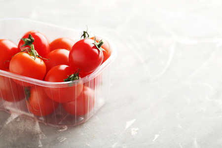 Fresh cherry tomatoes on a grey backgroundの写真素材