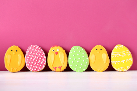 Colorful easter cookies on the pink background