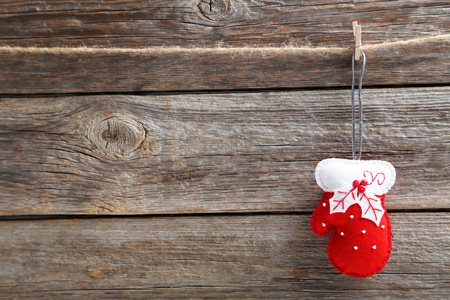 Christmas decoration hanging on rope on wooden backgroundの写真素材