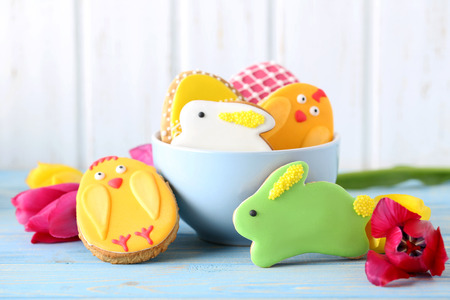 Colorful easter cookies on blue wooden background