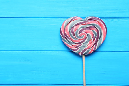 Sweet lollipop on blue wooden tableの写真素材