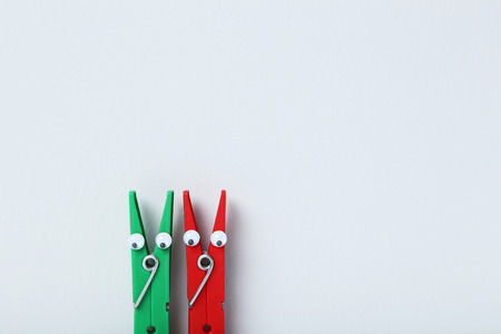 Plastic clothespins on a grey backgroundの写真素材