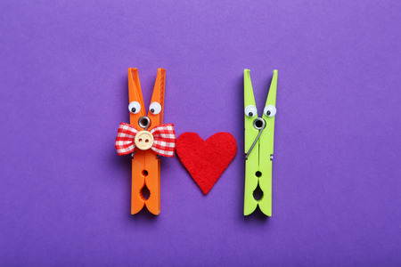 Plastic clothespins on a purple backgroundの写真素材