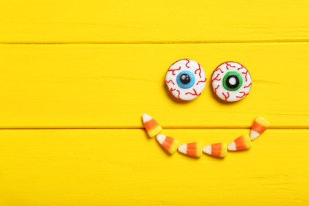 Fresh halloween gingerbread cookies on yellow wooden tableの写真素材