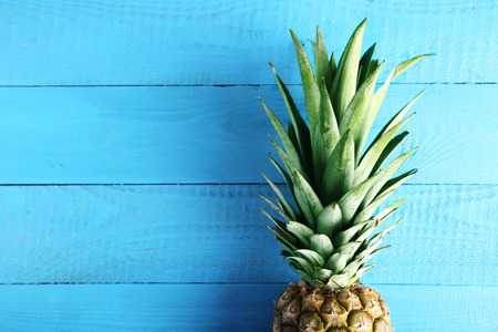 Ripe pineapple on a blue wooden tableの写真素材