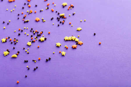 Colorful sprinkles on a purple backgroundの写真素材