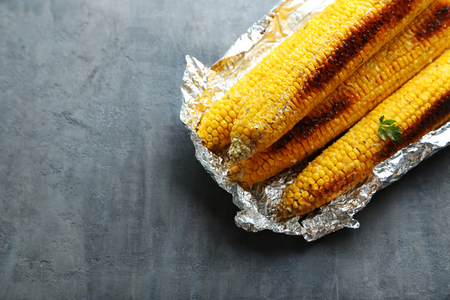 Tasty grilled corn on grey wooden tableの写真素材
